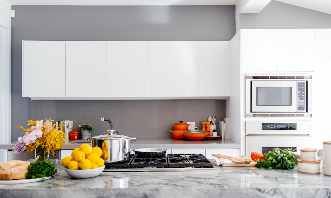 Happy homeowner admiring beautiful new kitchen countertops after professional installation