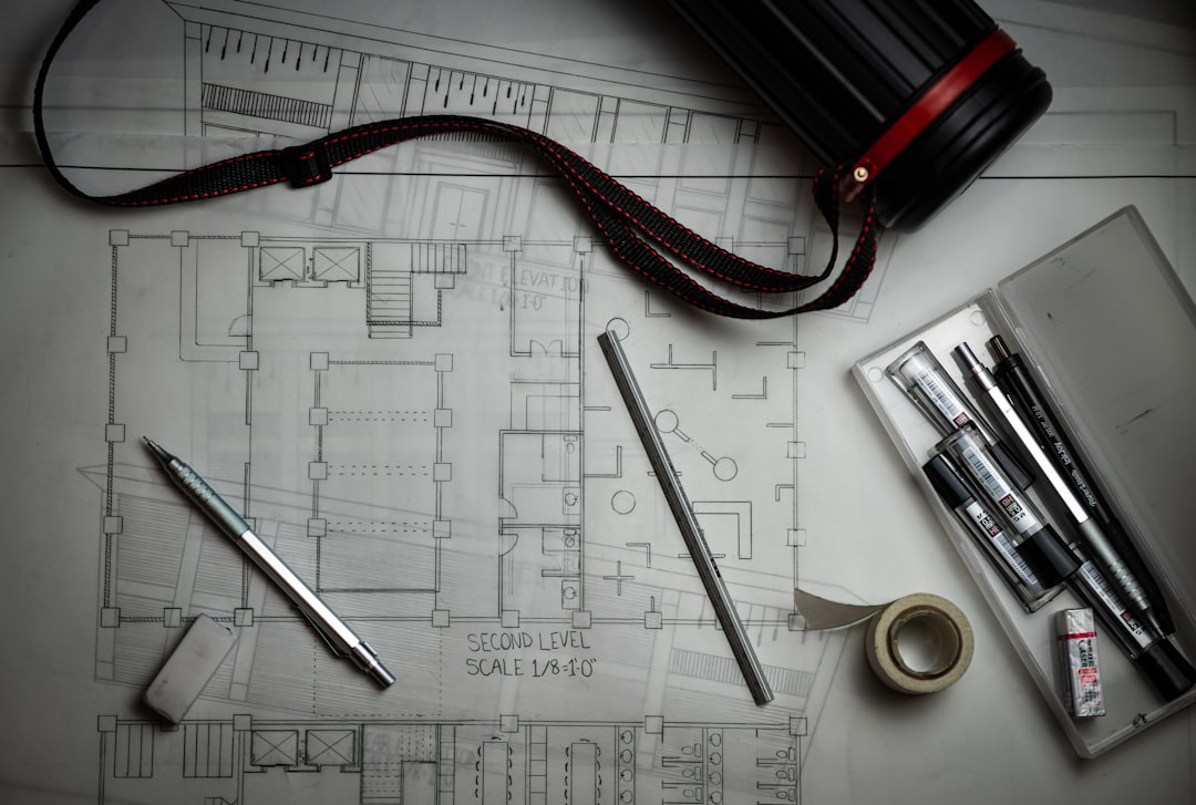 Architectural blueprints, drafting pencils, design plans and measurements on an office desk showing professional project planning