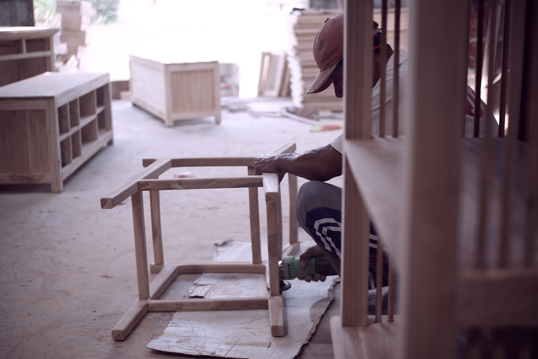 Professional cabinet installation showing precision carpentry work, skilled craftsperson fitting custom cabinetry
